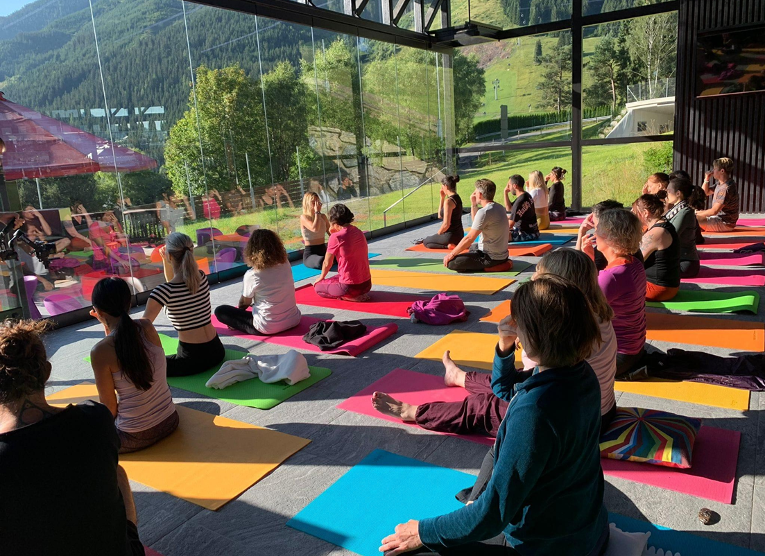 Breathing Techniques Class, beginners sit in front of large window learning breathwork from SOMA Breath