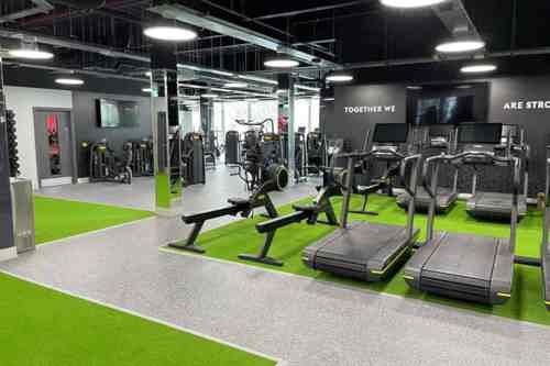 Village Gym interior with Technogym equipment.